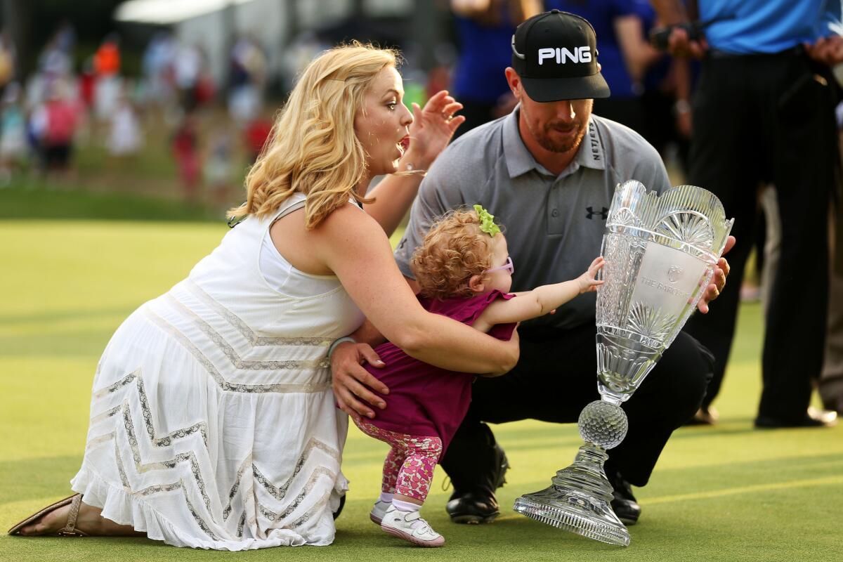 Hunter Mahan celebrates with his wife, Kandi, and daughter Zoe.