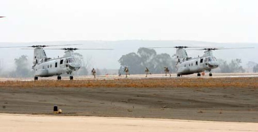 U.S. Marines exit CH-46 Sea Knight Helicopters during the annual air show aboard Marine Corps Air Station (MCAS) Miramar. Photo: U.S. Marine Corps Sgt. Keonaona C. Paulo, Courtesy DefenseImagery.mil