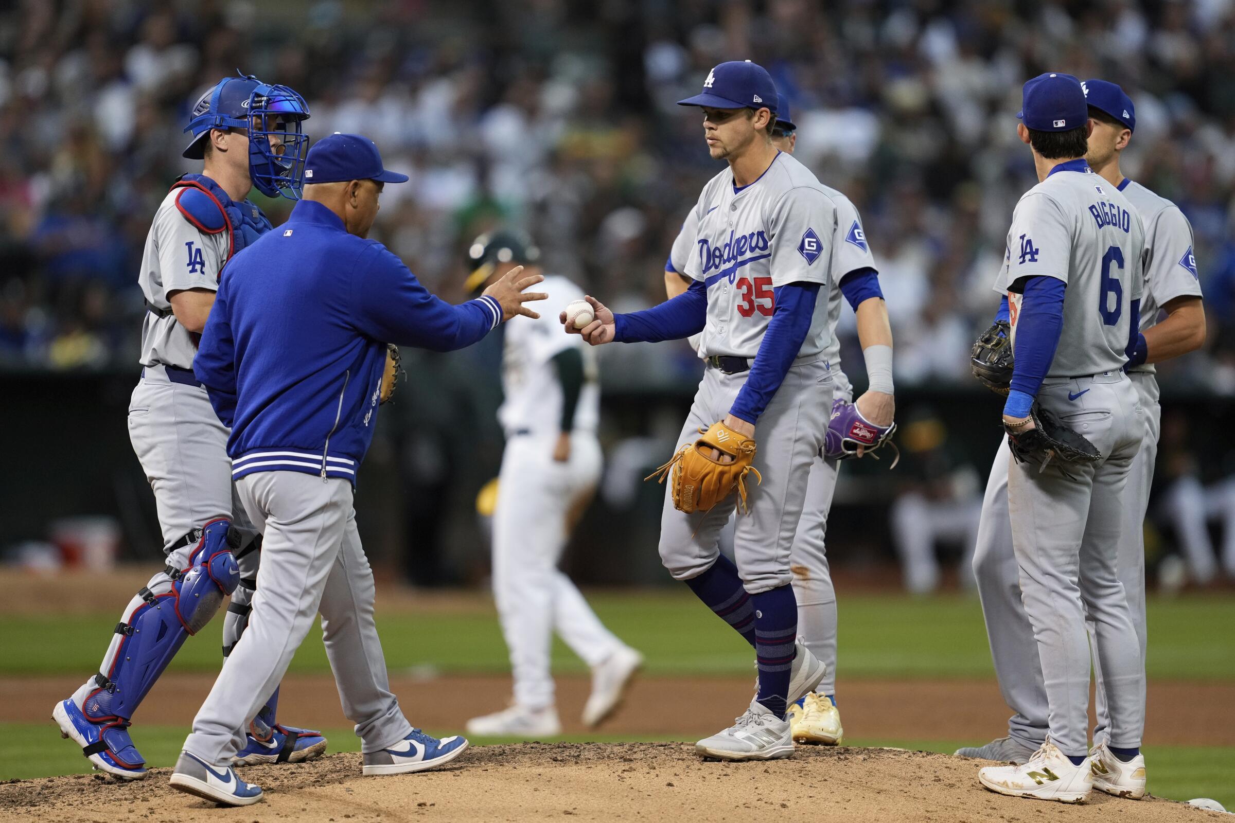 Dodgers pitcher Gavin Stone hands the ball over to manager Dave Roberts as he exits during the fifth inning 