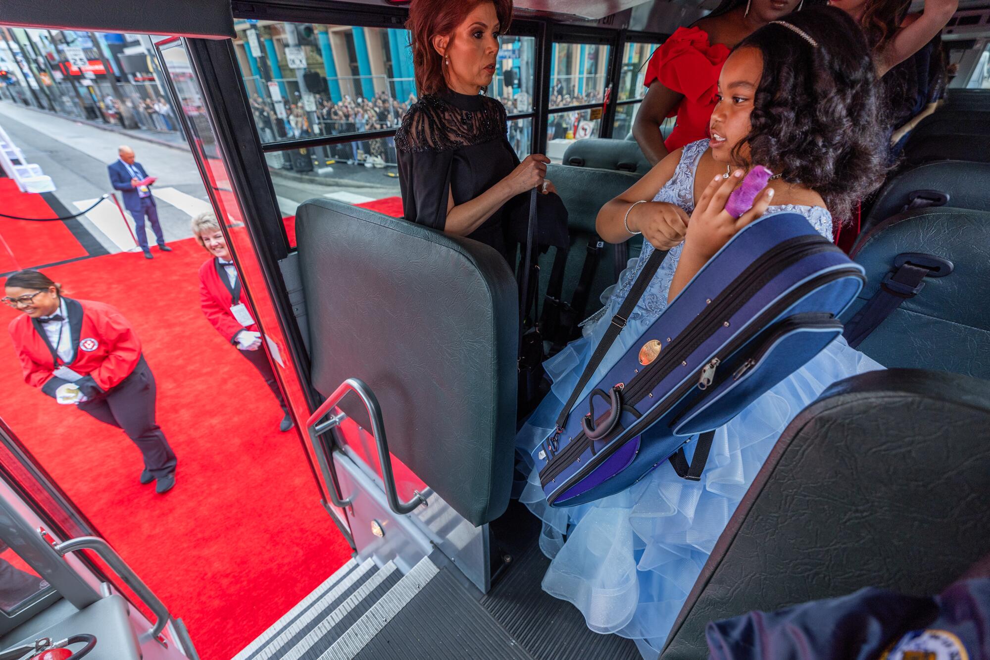 Attendees arrive on the red carpet in a LAUSD school bus at the Oscars.