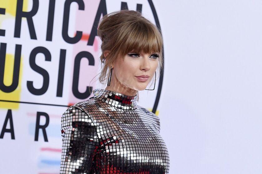 FILE - In this Oct. 9, 2018, file photo, Taylor Swift arrives at the American Music Awards at the Microsoft Theater in Los Angeles. Swift has donated $15,500 to a GoFundMe account of a fan whose family is struggling with medical bills. (Photo by Jordan Strauss/Invision/AP, File)