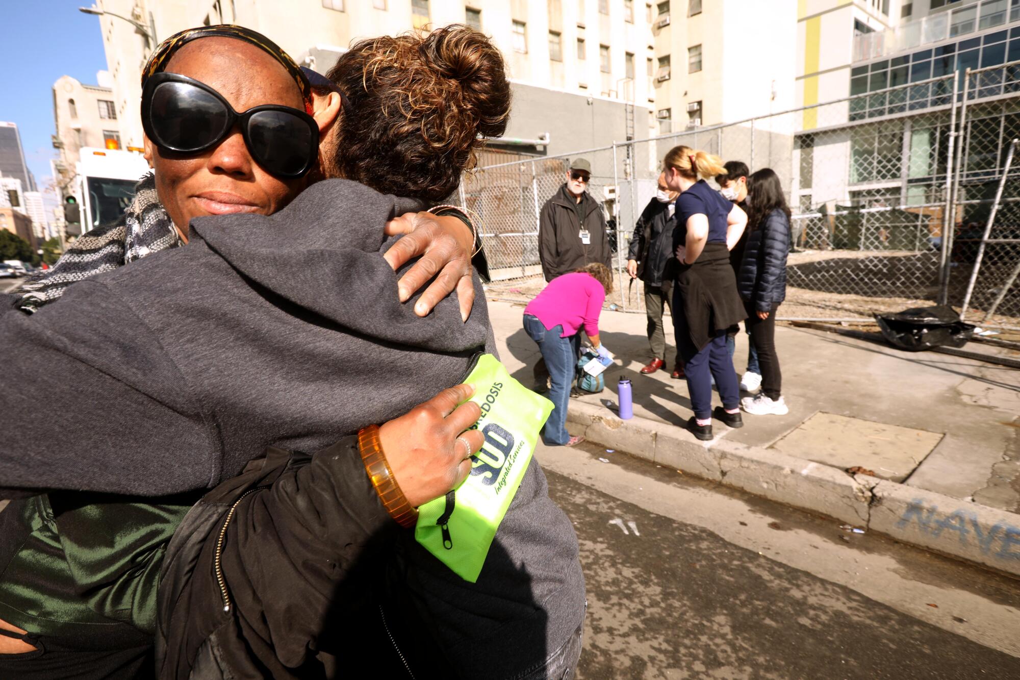 Amber Ross, left, receives a hug of support from outreach harm reduction specialist Sylvia Meza in Los Angeles.