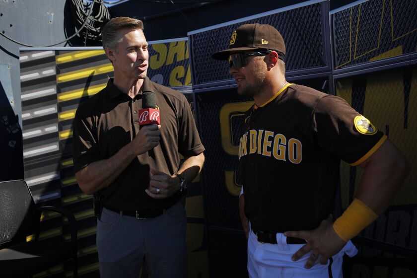 PEORIA, AZ - MARCH 23: Bally Sports field reporter Bob Scanlan interviews San Diego Padres' Luke Voit during a spring training game against the Los Angeles Angels on Wednesday, March 23, 2022 in Peoria, AZ. (K.C. Alfred / The San Diego Union-Tribune)