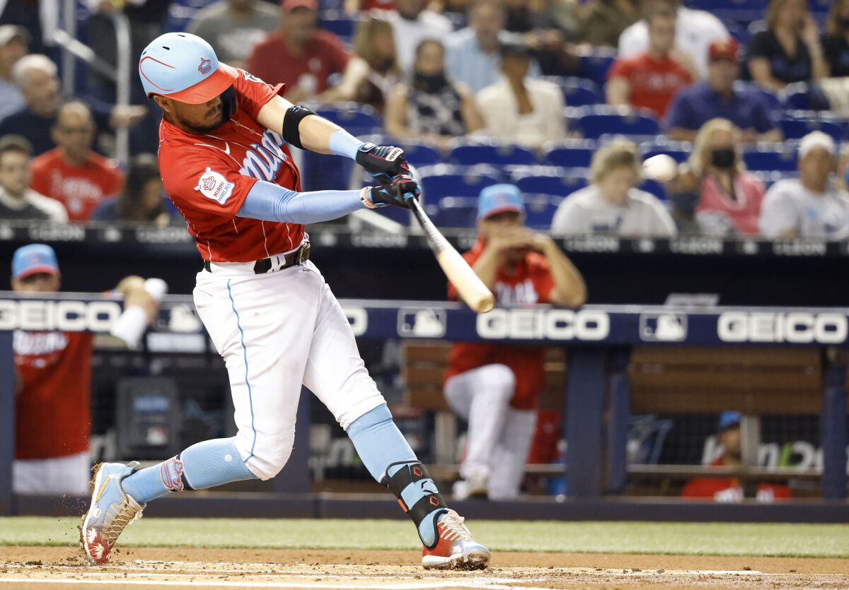 Miami Marlins' Miguel Rojas doubles during the first inning against the Philadelphia Phillies in a baseball game Saturday, Sept. 4, 2021, in Miami. (AP Photo/Rhona Wise)