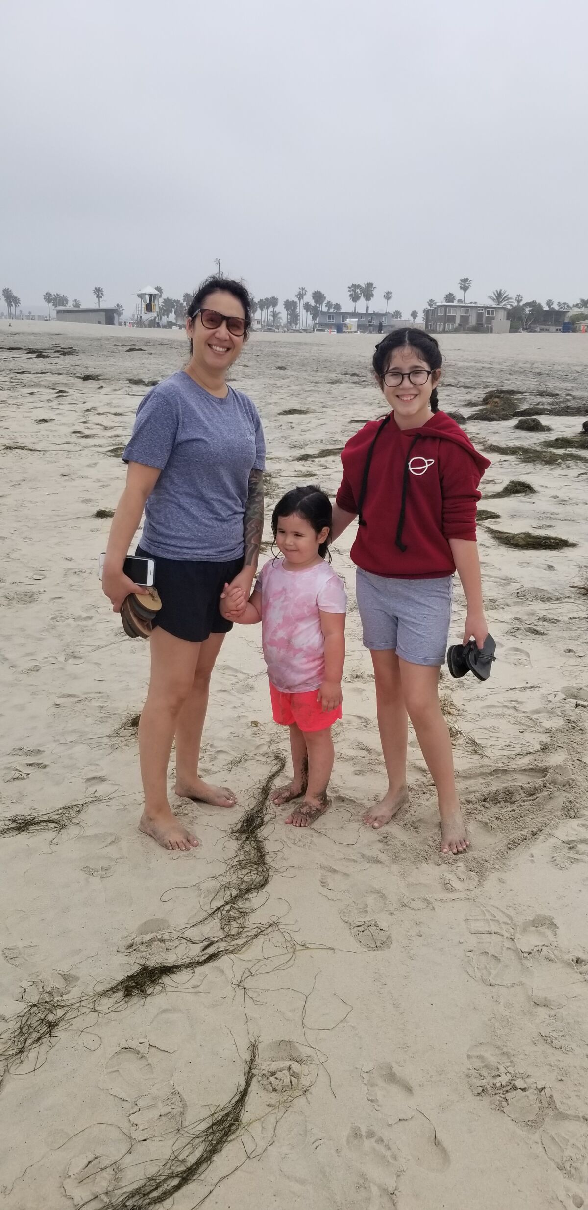 Emy Mills, on a walk with her daughters Eloise and Ema in Ocean Beach, said, “Honestly, I feel safer being out here at the beach than at a grocery store.”