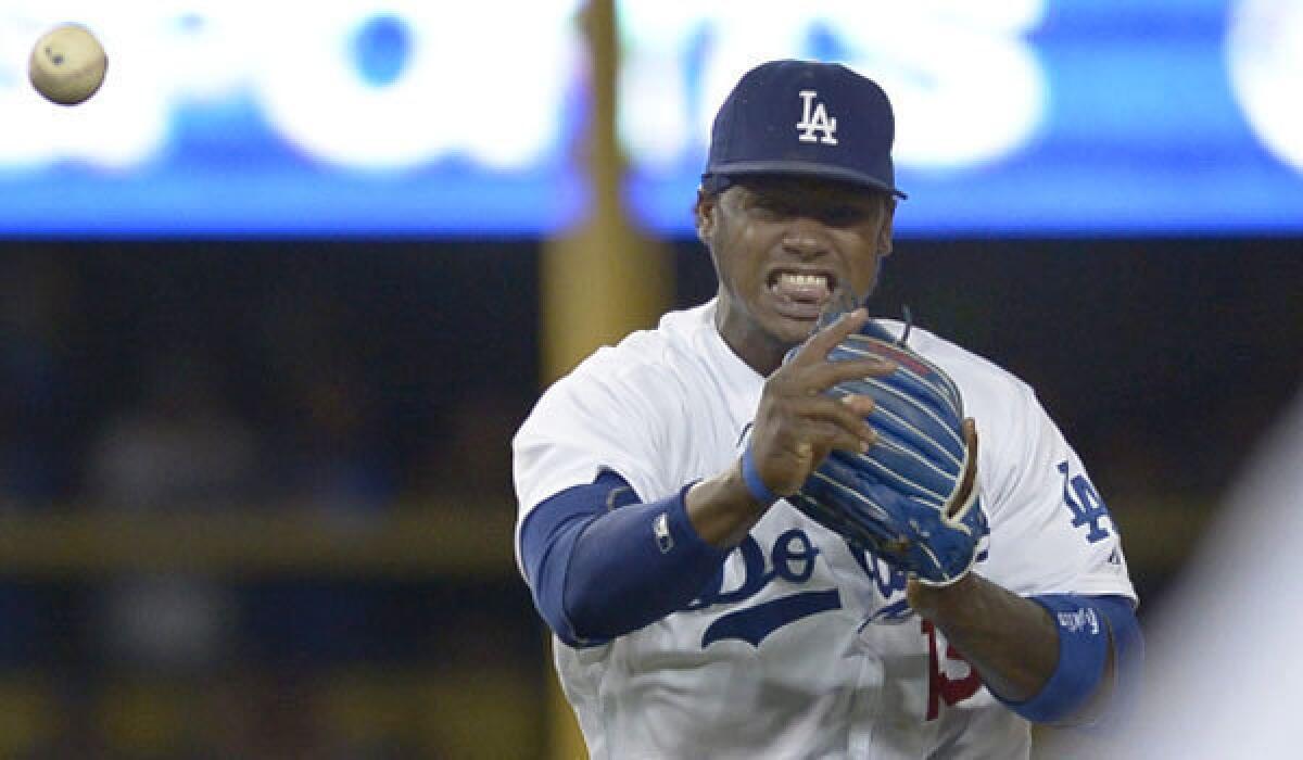 Dodgers shortstop Hanley Ramirez grimaces as he throws to first base on Thursday.