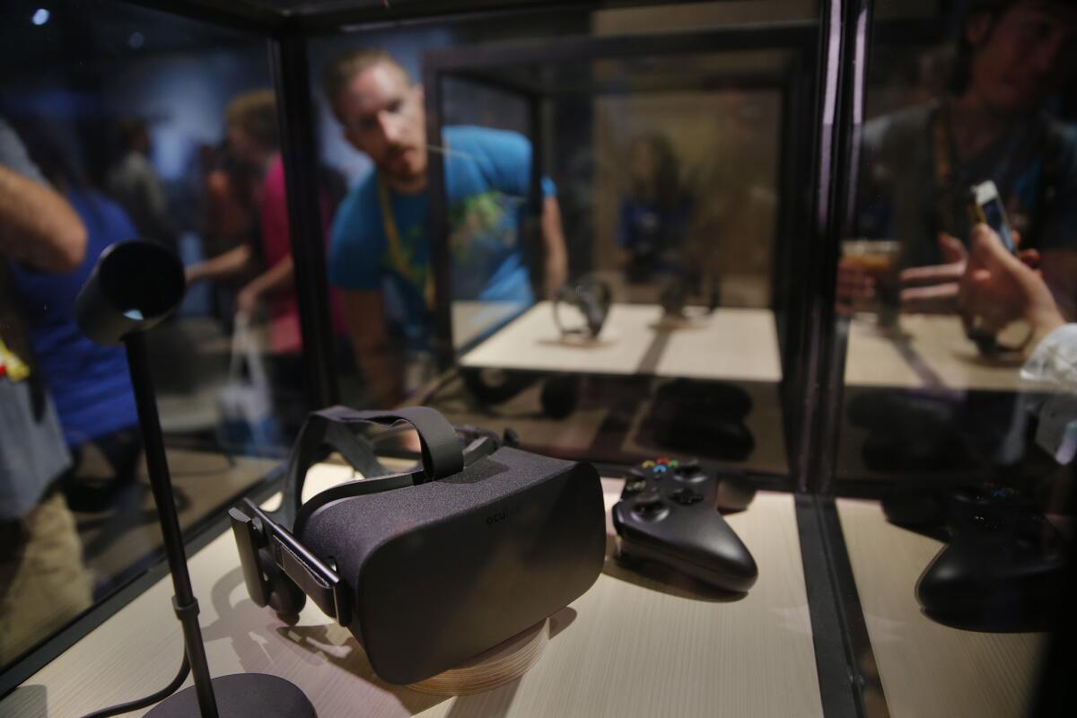 Video game enthusiasts view the Oculus Rift during a video game industry trade show in Los Angeles in June 2015.