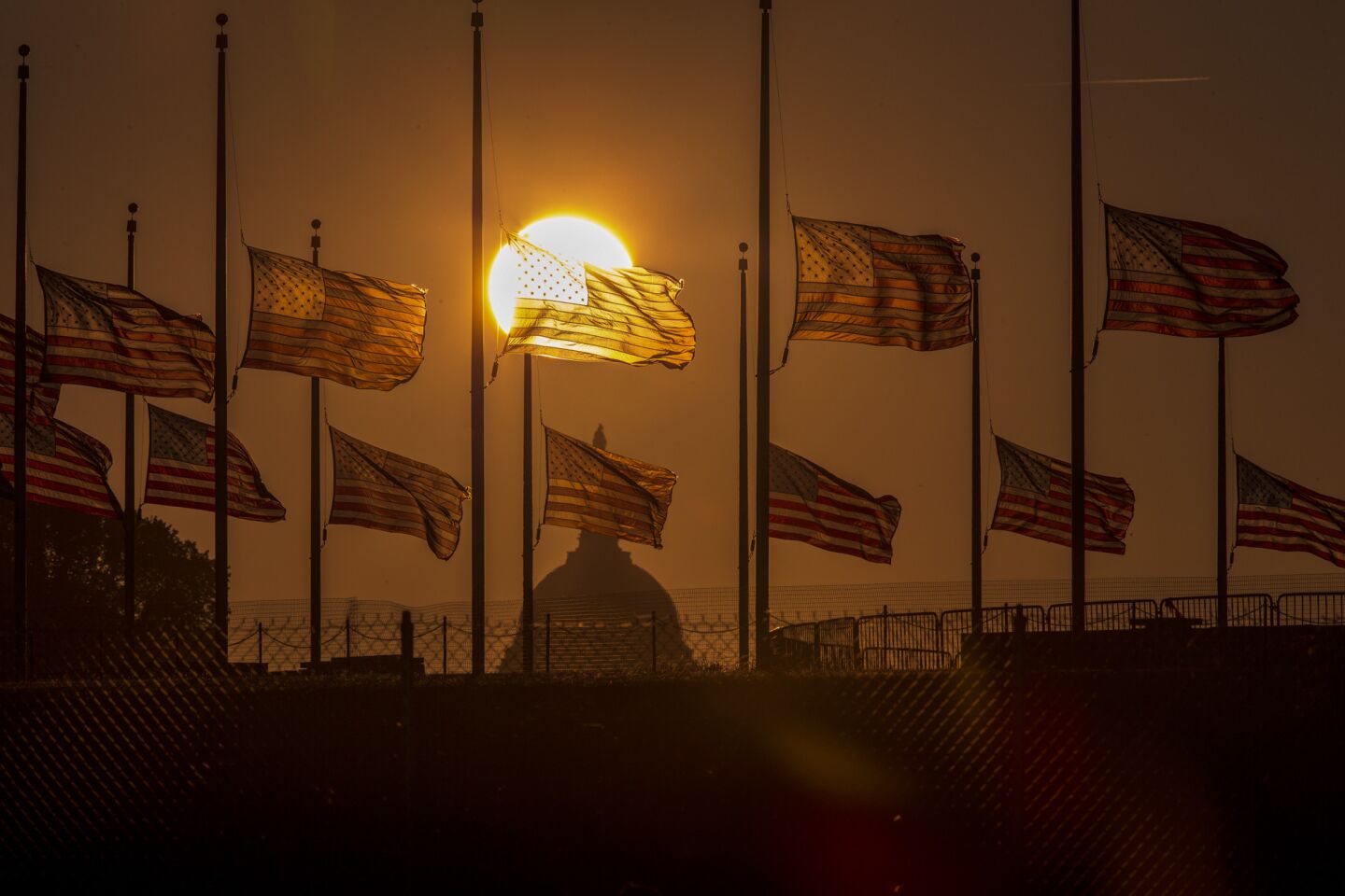 Flags surrounding the Washington Monument fly at half staff after the deadly shooting at the Washington Navy Yard.