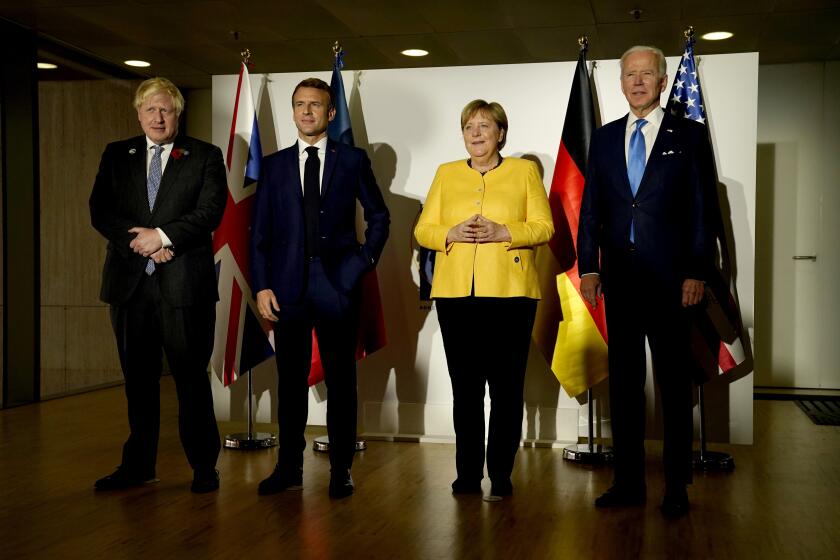 From right, U.S. President Joe Biden, German Chancellor Angela Merkel, French President Emmanuel Macron and British Prime Minister Boris Johnson pose prior to a meeting on the sidelines of the G20 summit in Rome, Saturday, Oct. 30, 2021. The two-day Group of 20 summit is the first in-person gathering of leaders of the world's biggest economies since the COVID-19 pandemic started. (AP Photo/Evan Vucci)