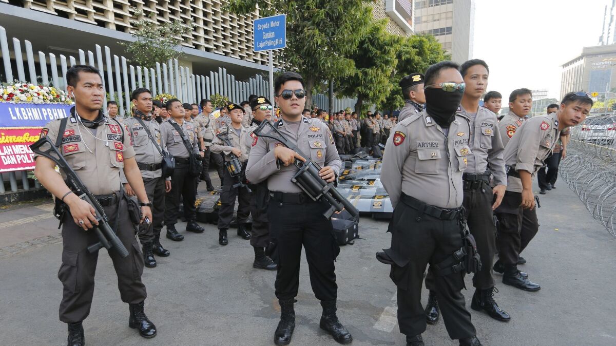 Riot police stand guard outside the General Election Supervisory Board building in anticipation of protests in Jakarta, Indonesia, this week.