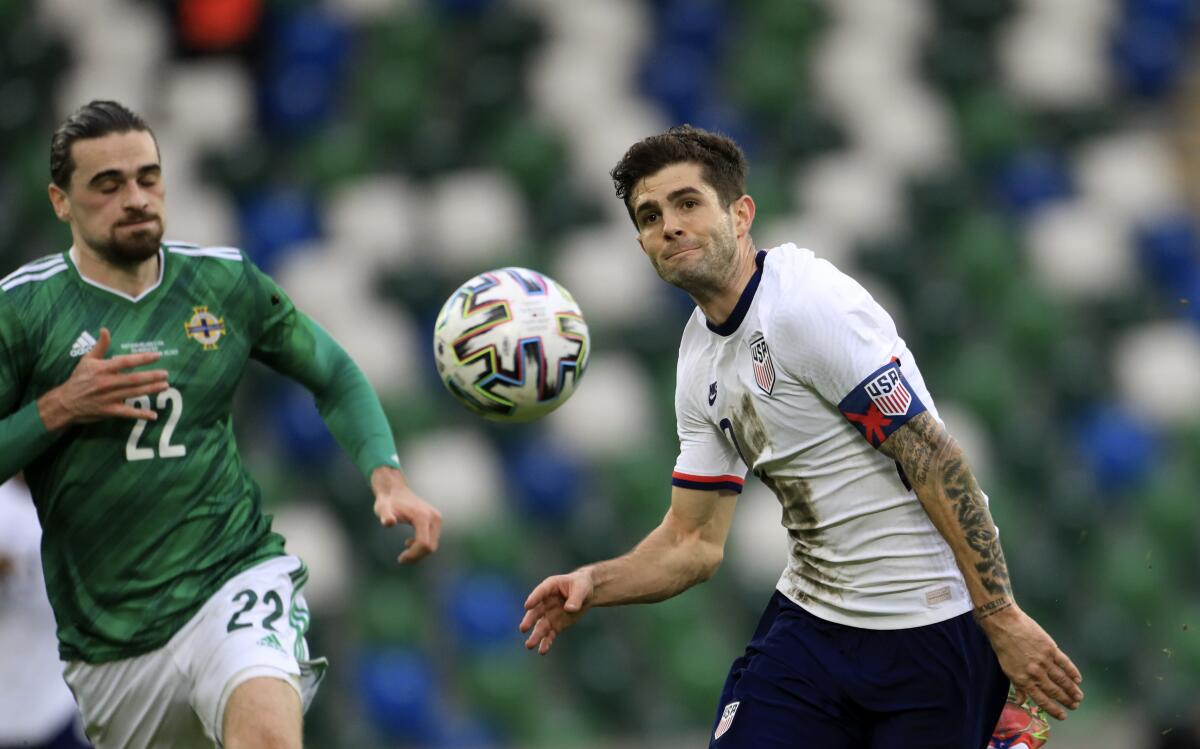 Christian Pulisic duels for the ball with Northern Ireland's Ciaron Brown.