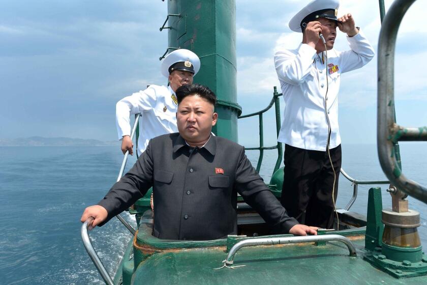 North Korean leader Kim Jong Un, center, inspects a submarine belonging to the Korean People's Army.