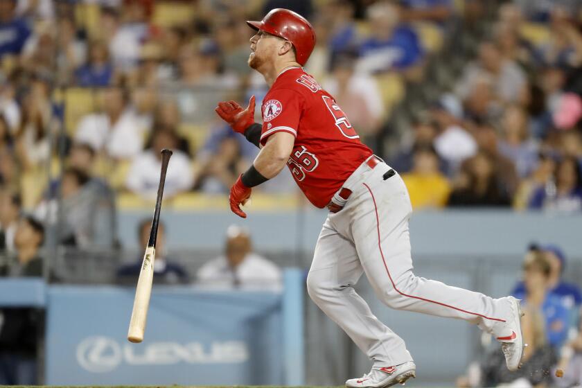 LOS ANGELES, CALIF. - JULY 24, 2019. Angels right fielder Kole Calhoun tosses his bat after hitting a home run against the Dodgers in the fourth inning Wednesday night, July 24, 2019, at Dodger Stadium in Los Angeles. (Luis Sinco/Los Angeles Times)