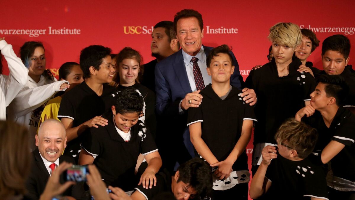 Former California Gov. Arnold Schwarzenegger appears with a local dance group at an event at USC highlighting after-school programs. He criticized President Trump at the event and in an interview afterward.