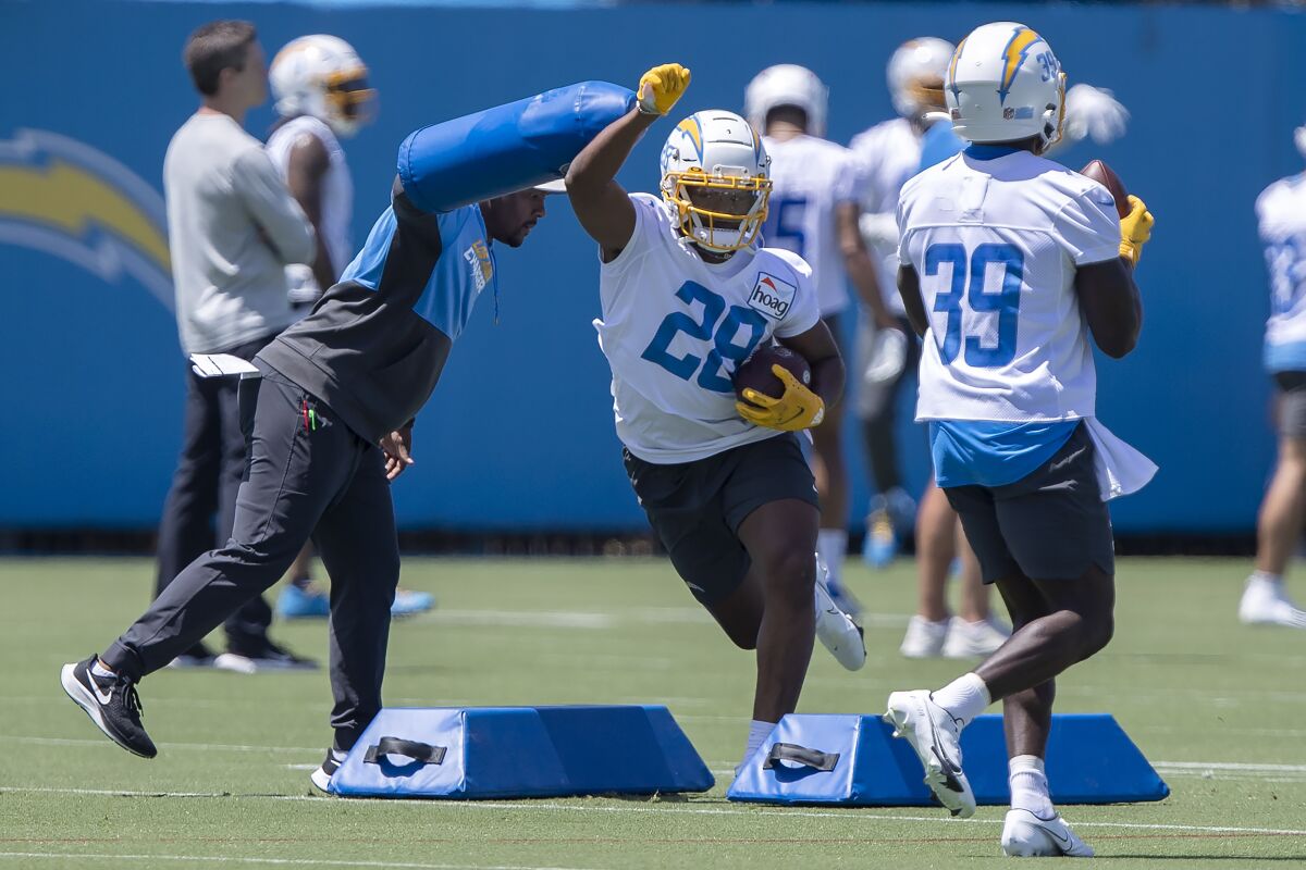 Chargers rookie running back Isaiah Spiller (28) takes part in drills during practice.
