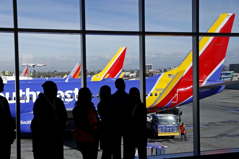 LOS ANGELES, CA - NOVEMBER 30, 2018. Southwest Airlines staff with Southwest planes as a backdrop during a ceremony unveiling the new Terminal 1 at Los Angeles International Airport (LAX) November 30, 2018. Southwest is the exclusive carrier of Terminal 1 at LAX. Southwest and Los Angeles World Airports (LAWA) partnered with Unibail-Rodamco-Westfield (URW Airports) to spend $516.7 million on an expanded dining and retail program showcasing local LA brands. (Al Seib / Los Angeles Times)
