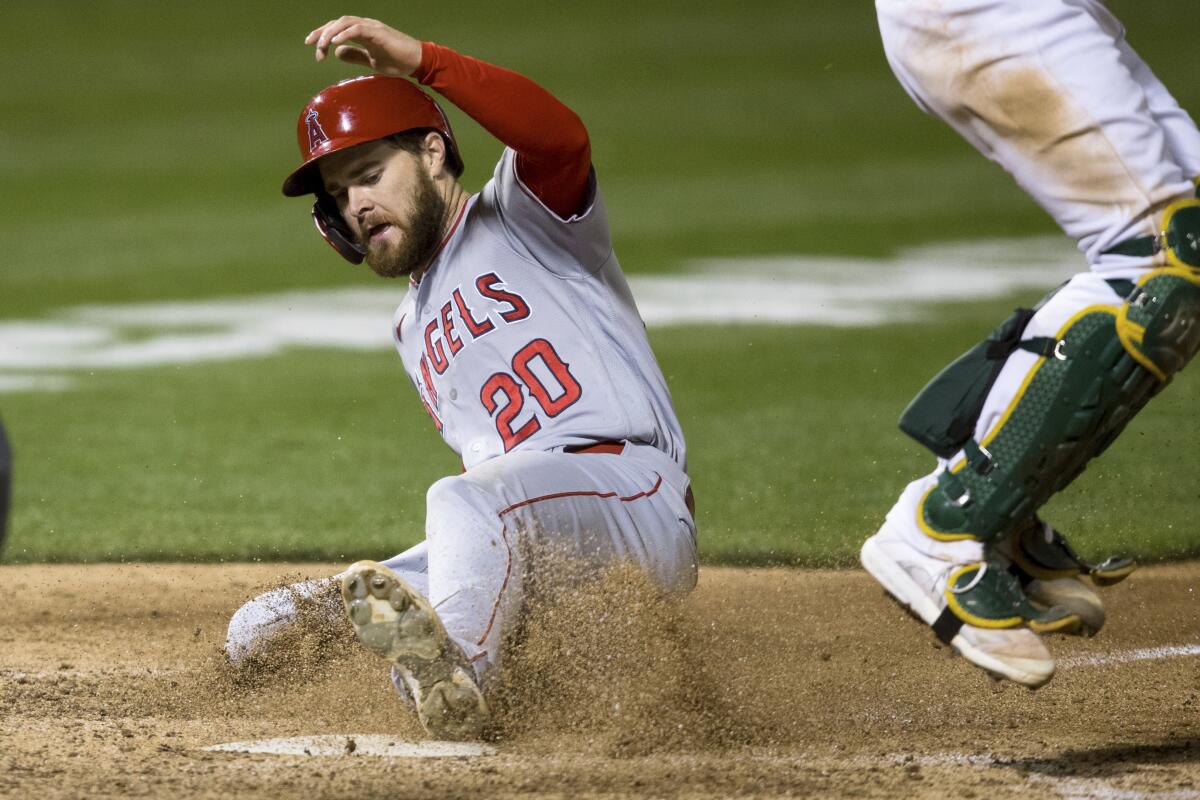 Angels baserunner Jared Walsh scores against the Oakland Athletics in the seventh inning Monday.