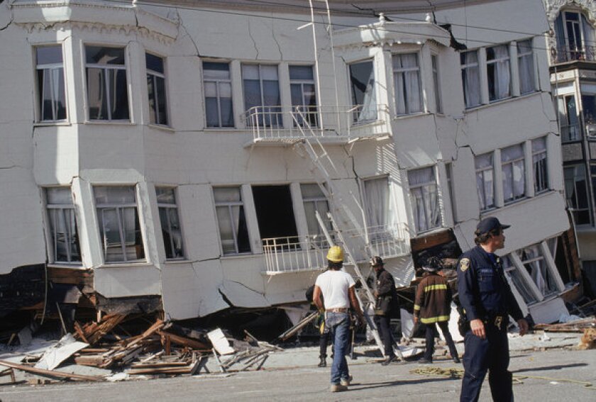 Firefighters stand outside a building in San Francisco's Marina district that failed in the 1989 Loma Prieta earthquake. Los Angeles hopes to follow San Francisco's lead in upgrading "soft-story" buildings.