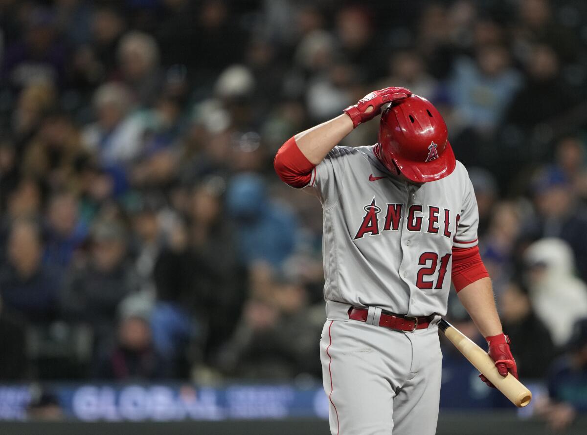 Angels' Matt Thaiss walks away after striking out against Seattle Mariners starting pitcher Luis Castillo.