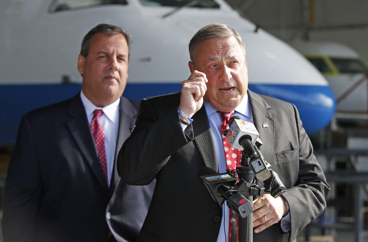 One does, the other doesn't: New Jersey's GOP Gov. Chris Christie, left, expanded Medicaid under the Affordable Care Act; Maine's GOP Gov. Paul LePage, right, has refused, but trails in his reelection race.