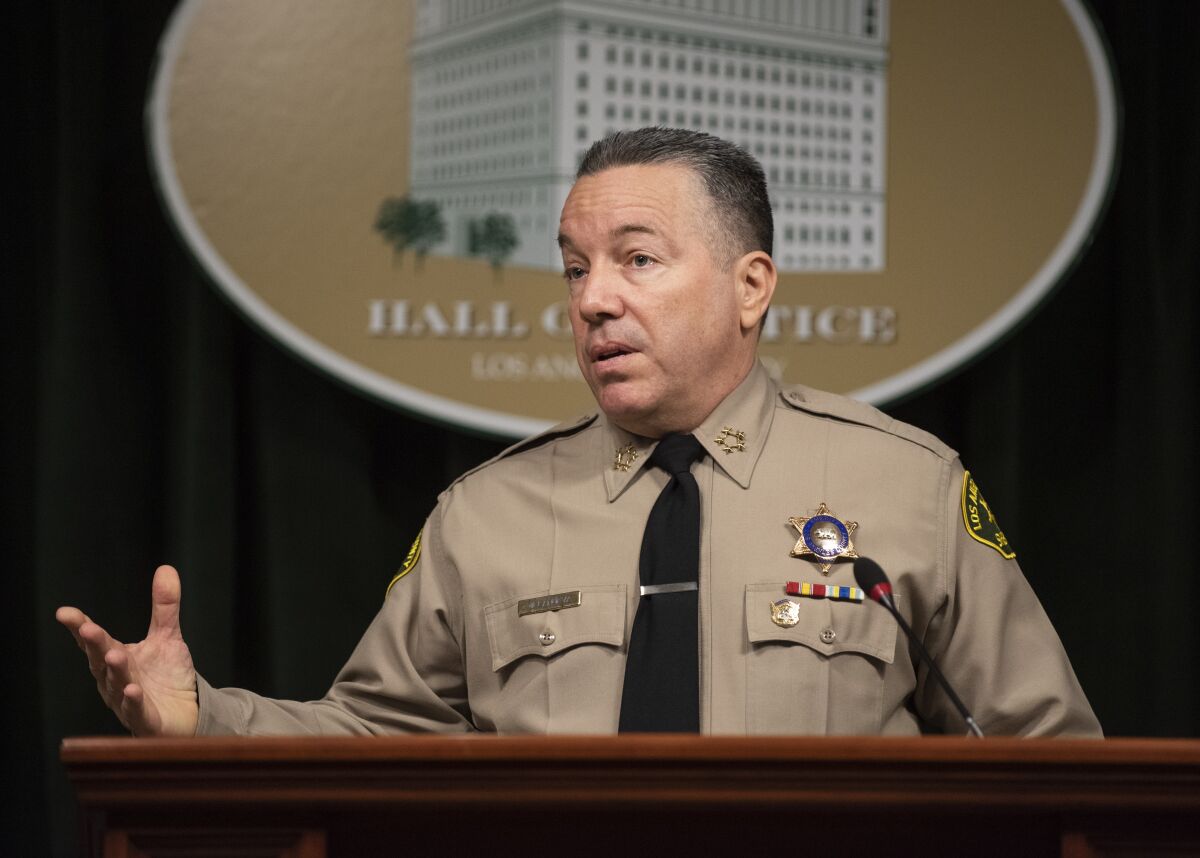 Sheriff Alex Villanueva speaks from behind a lectern