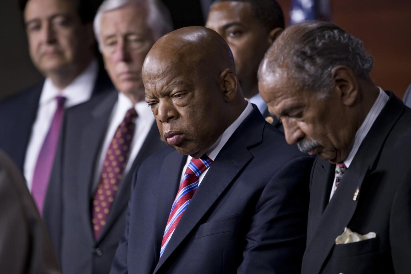 Rep. John Lewis and other lawmakers stand at a news conference