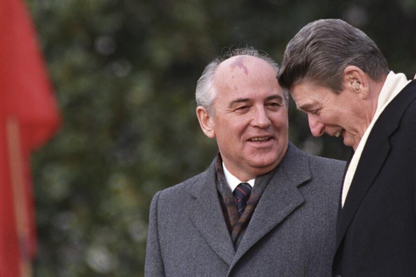 FILE - U.S. President Ronald Reagan, right, talks with Soviet leader Mikhail Gorbachev during arrival ceremonies at the White House where the superpowers begin their three-day summit talks in Washington, D.C., Tuesday, Dec. 8, 1987. Russian news agencies are reporting that former Soviet President Mikhail Gorbachev has died at 91. The Tass, RIA Novosti and Interfax news agencies cited the Central Clinical Hospital. (AP Photo/Boris Yurchenko, File)