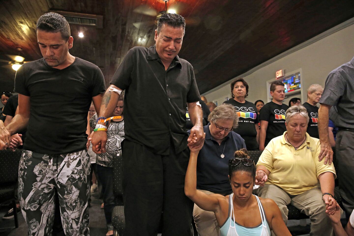 Orlando, second from right, was at the nightclub and trapped for three hours in a bathroom. Orlando and family attend a vigil and church service held at Joy Meropolitan Community Church very close to Pulse nightclub.