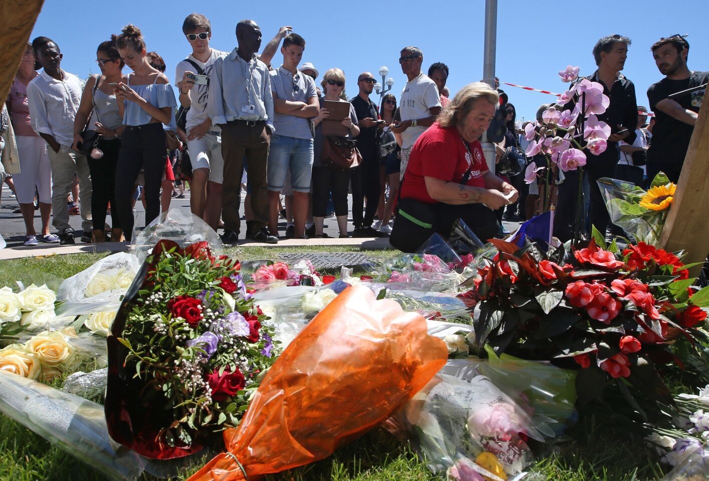 Floral tributes are placed near the site of the truck attack in the French resort city of Nice.