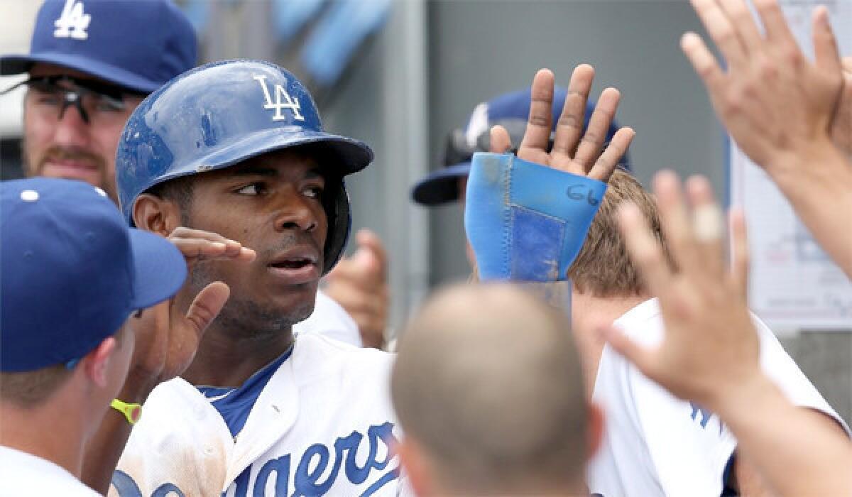 Dodgers outfielder Yasiel Puig has been named the NL player of the month and rookie of the month for June.