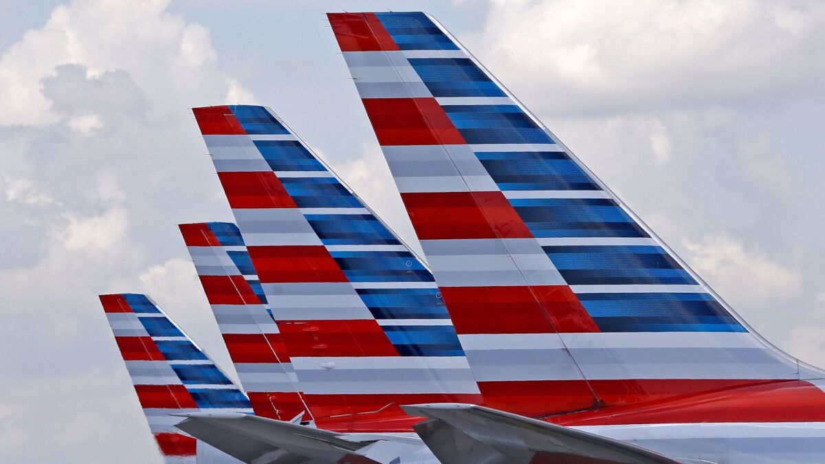 Four American Airlines passenger planes sit parked at Miami International Airport. A computer error has allowed too many pilots at the Fort Worth-based airline to take time off for the Christmas holiday.