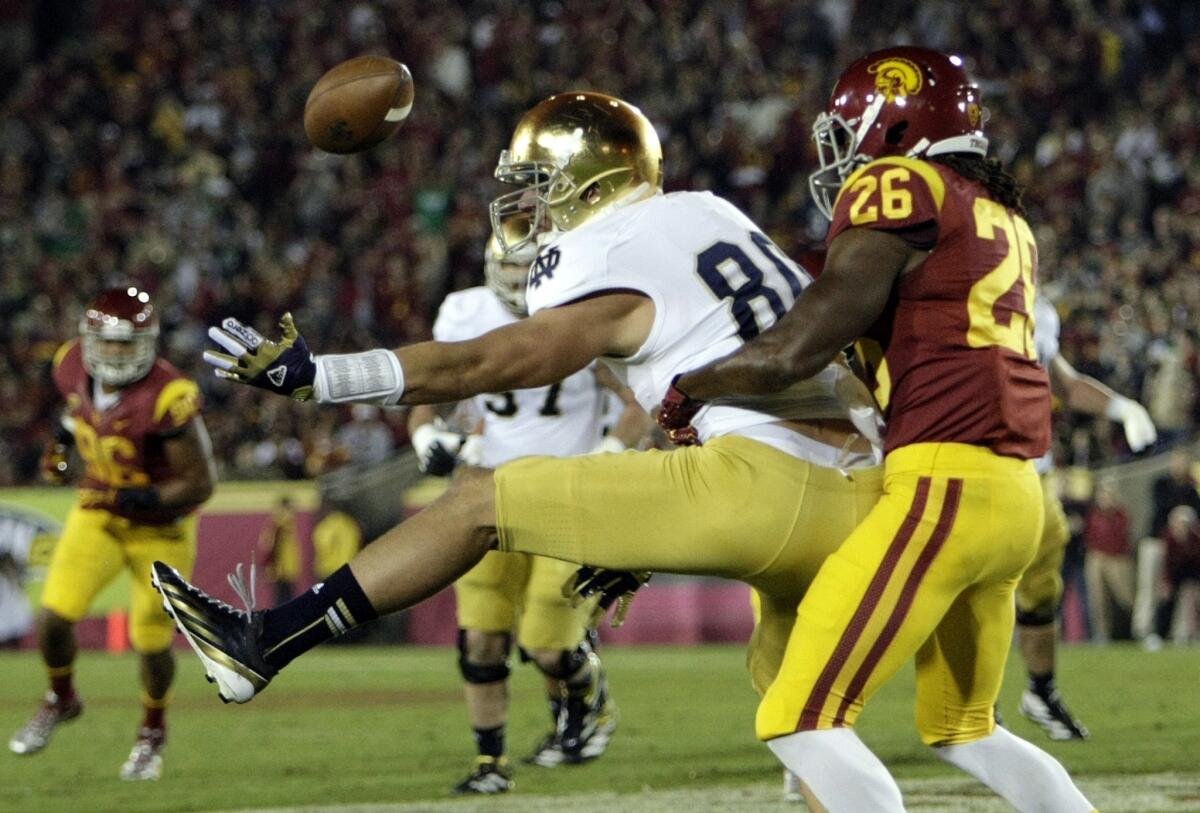 USC safety Josh Shaw tries to break up a pass to Notre Dame receiver John Goodman in 2012.