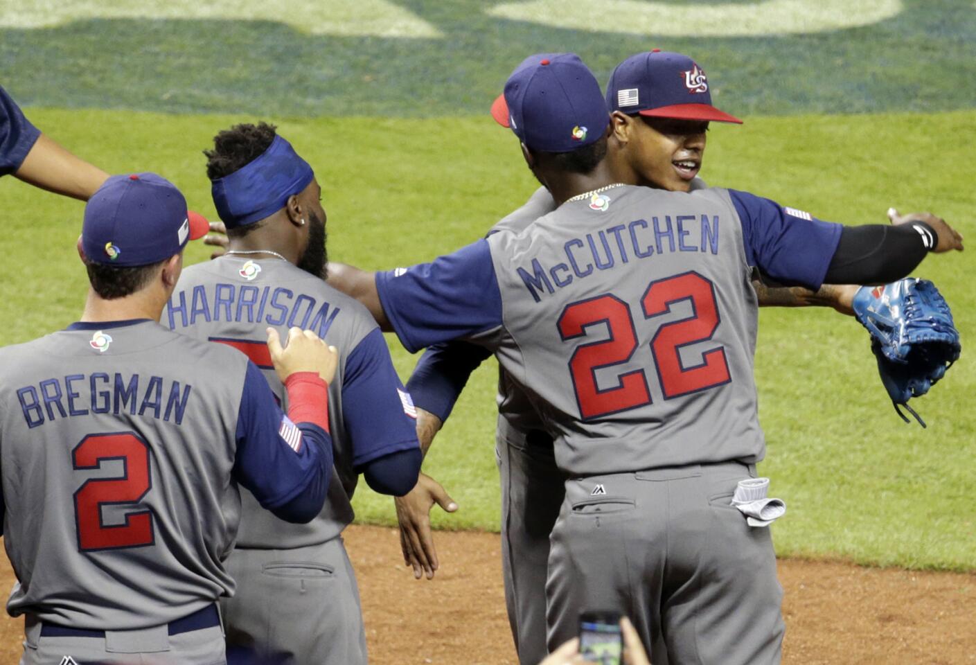 U.S. starting pitcher Marcus Stroman, right rear, is hugged by outfielder Andrew McCutchen (22) after being relieved during the sixth inning against the Dominican Republic in a first-round game of the World Baseball Classic, Saturday, March 11, 2017, in Miami. (AP Photo/Lynne Sladky)