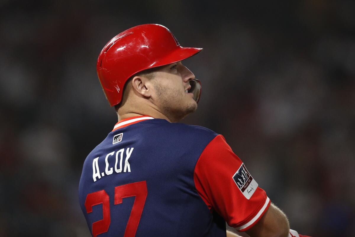Los Angeles Angels' Mike Trout wears a jersey bearing a name of his brother-in-law, Aaron Cox, during the sixth inning of a baseball game against the Houston Astros, Friday, Aug. 24, 2018, in Anaheim, Calif. Cox, a former minor-league baseball player, died at 24 on Aug. 15.