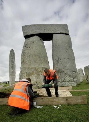 Archaeology students Steve Bush, right, and Sam Ferguson, left, sieve through earth amongst the stones at Stonehenge.