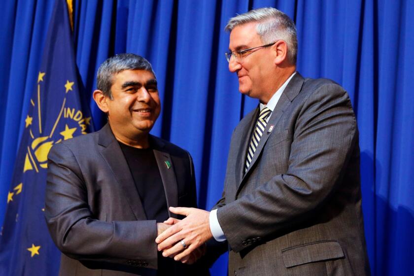 Indiana Gov. Eric J. Holcomb, right, greets Dr. Vishal Sikka, CEO of Infosys, following an announcement at the Statehouse in Indianapolis, Tuesday, May 2, 2017, plans for Infosys to increase its operations in the U.S, establishing four new state-of-the-art technology and innovation hubs in the U.S., with the first one in Indiana. (AP Photo/Michael Conroy)