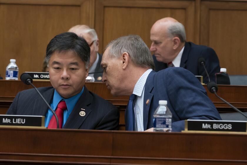 Rep. Ted Lieu, D-Calif., left, and Rep. Andy Biggs, R-Ariz., the newly-elected chairman of the conservative House Freedom Caucus, confer during debate by the House Judiciary Committee as they work on guidelines for impeachment hearings on President Donald Trump, at the Capitol in Washington, Thursday, Sept. 12, 2019. (AP Photo/J. Scott Applewhite)