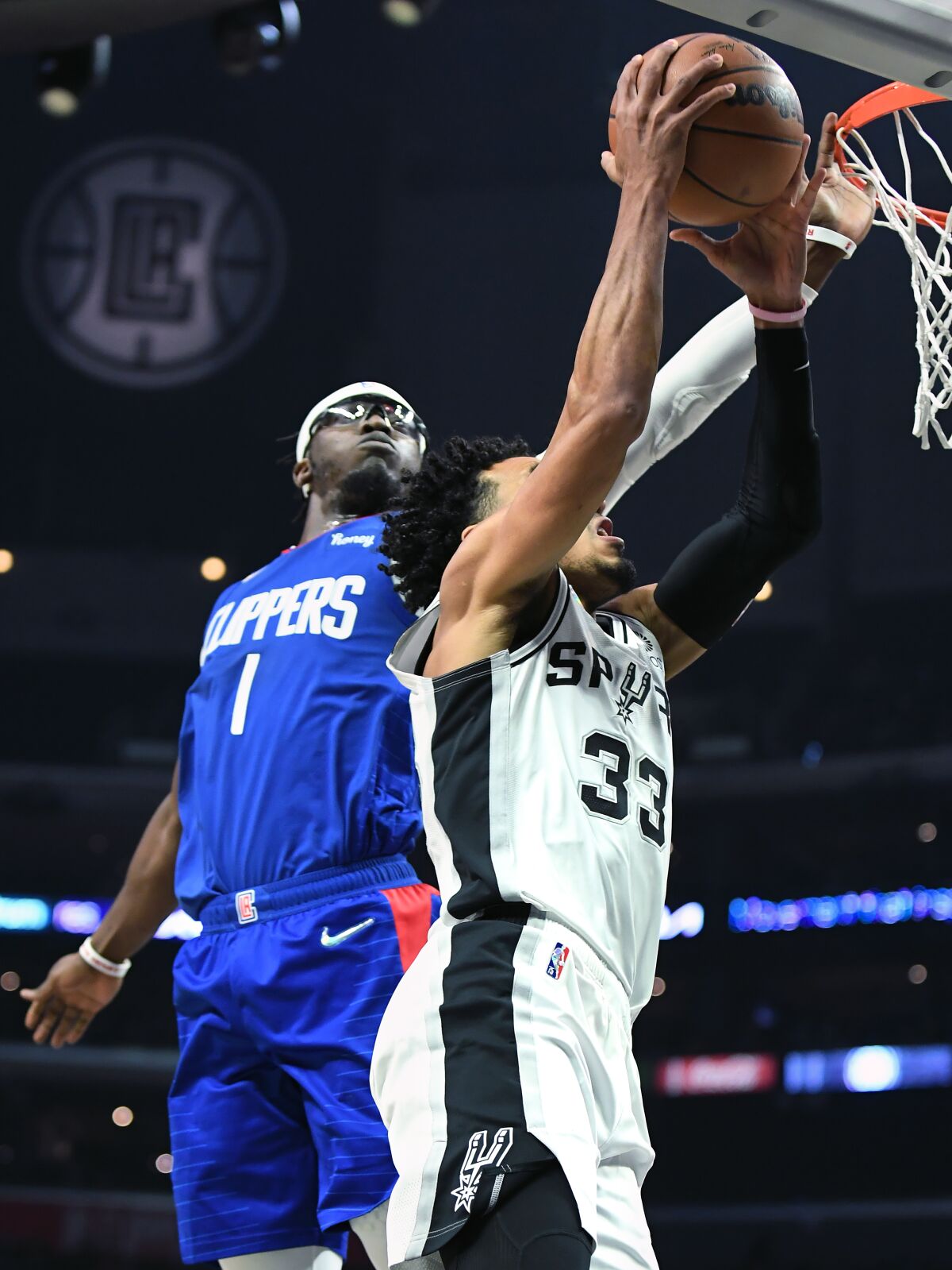 Clippers' Reggie Jackson blocks the shot of San Antonio Spurs' Tre Jones.