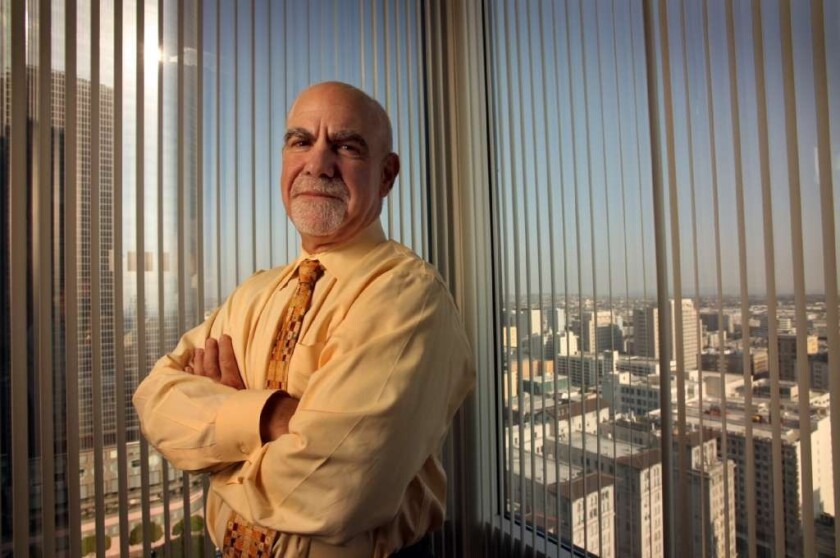 Howard A. Kahn, chief executive of L.A. Care Health Plan, said he will step down in January 2015. Above, Kahn in his downtown L.A. office in 2009.