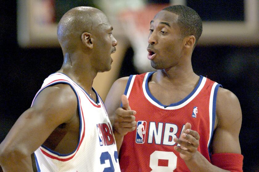 Washington Wizards Michael Jordan with the East All–Star Squad and and Los Angeles Lakers Kobe Bryant with the West All–Star Squad chat during the second half of the 52nd NBA All–Star game in Atlanta, February 9, 2002. The West All–Stars defeated the East All–Stars, 155–145. REUTERS/Alan Mothner