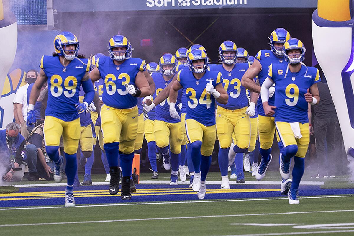 Rams players take the field.
