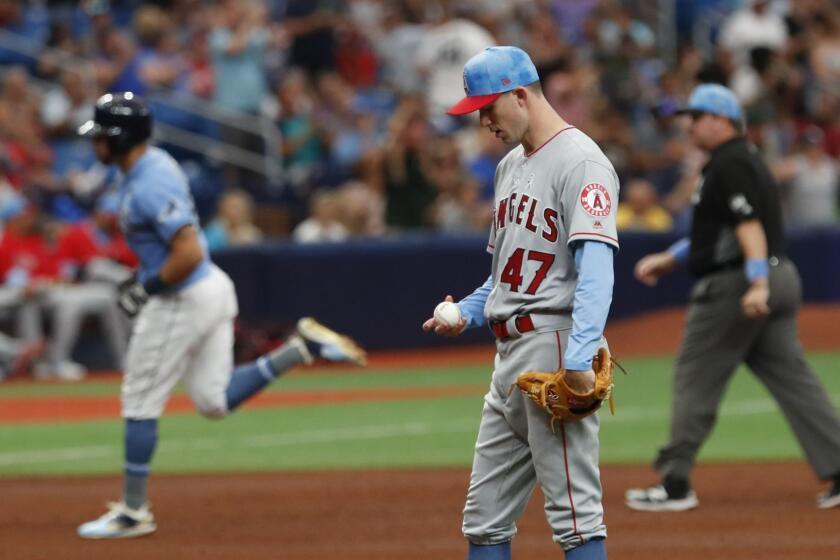 Los Angeles Angels pitcher Griffin Canning gives up a home run to Tampa Bay Rays Tommy Pham, behind left, during the fifth inning of a baseball game Sunday, June 16, 2019, in St. Petersburg, Fla. (AP Photo/Scott Audette)