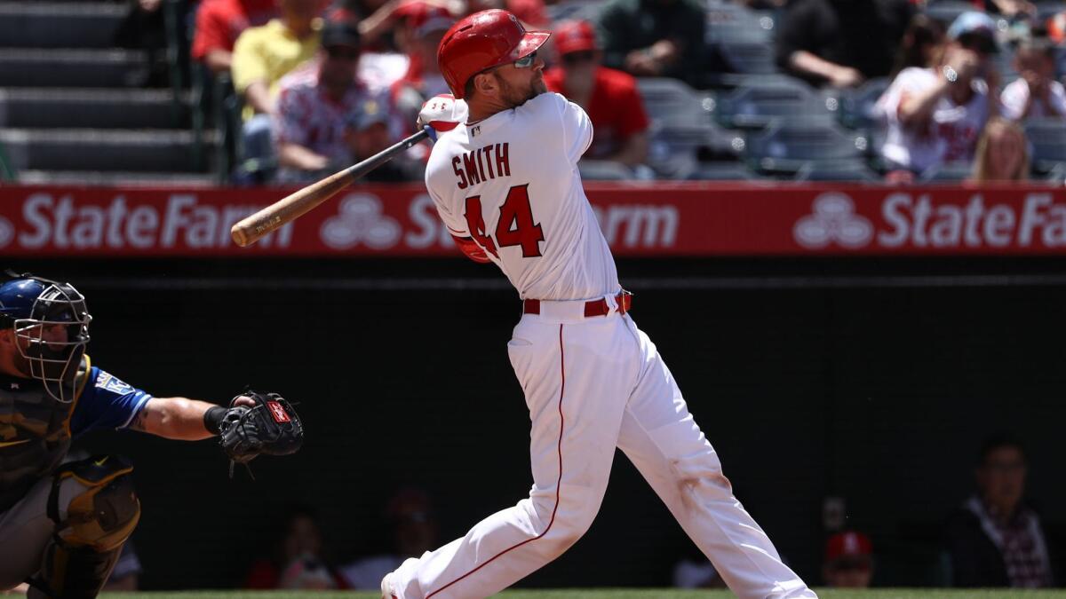 Angels catcher Kevan Smith hits an RBI double in the fourth inning against the Kansas City Royals at Angel Stadium on Sunday.