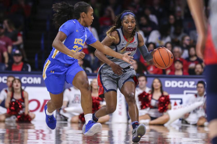 UCLA's Charisma Osborne defends Arizona's Aari McDonald during a game Jan. 31, 2020.