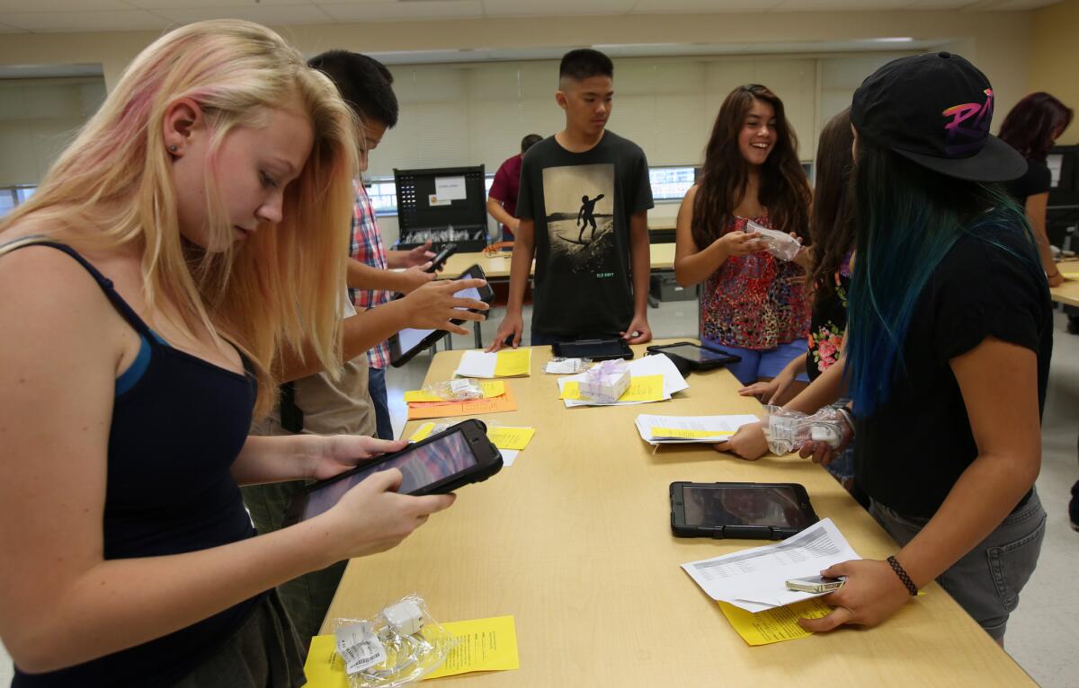 Students at the Valley Academy of Arts and Sciences in Granada Hills get iPads as part of their pre-first day orientation this month.