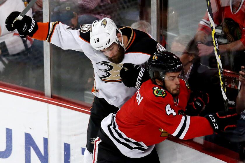 Ducks left wing Patrick Maroon check Niklas Hjalmarsson along the boards during Game 6.