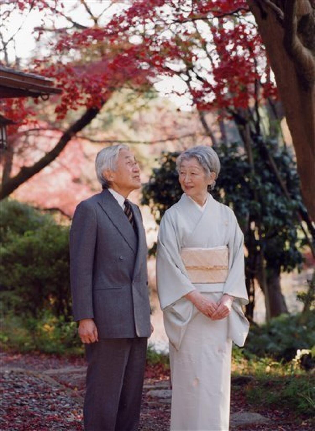In this photo taken on Monday, Nov. 29, 2010 and released by the Imperial Household Agency of Japan, Emperor Akihito and Empress Michiko admire autumn leaves during their stroll at Fukiage Garden in the Imperial Palace in Tokyo. Akihito celebrates his 77th birthday Thursday, Dec. 23, 2010. (AP Photo/Imperial Household Agency of Japan) EDITORIAL USE ONLY