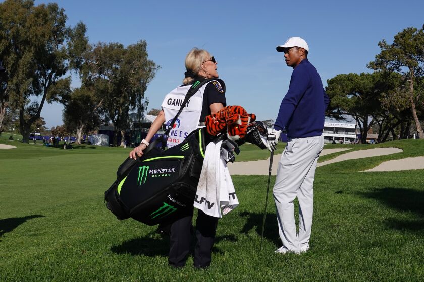 San Diego Police officer Deborah Ganley caddied for Tiger Woods on the 18th hole of Torrey Pines South Course during the Farmers Insurance Open Pro-Am on Jan. 22, 2020.