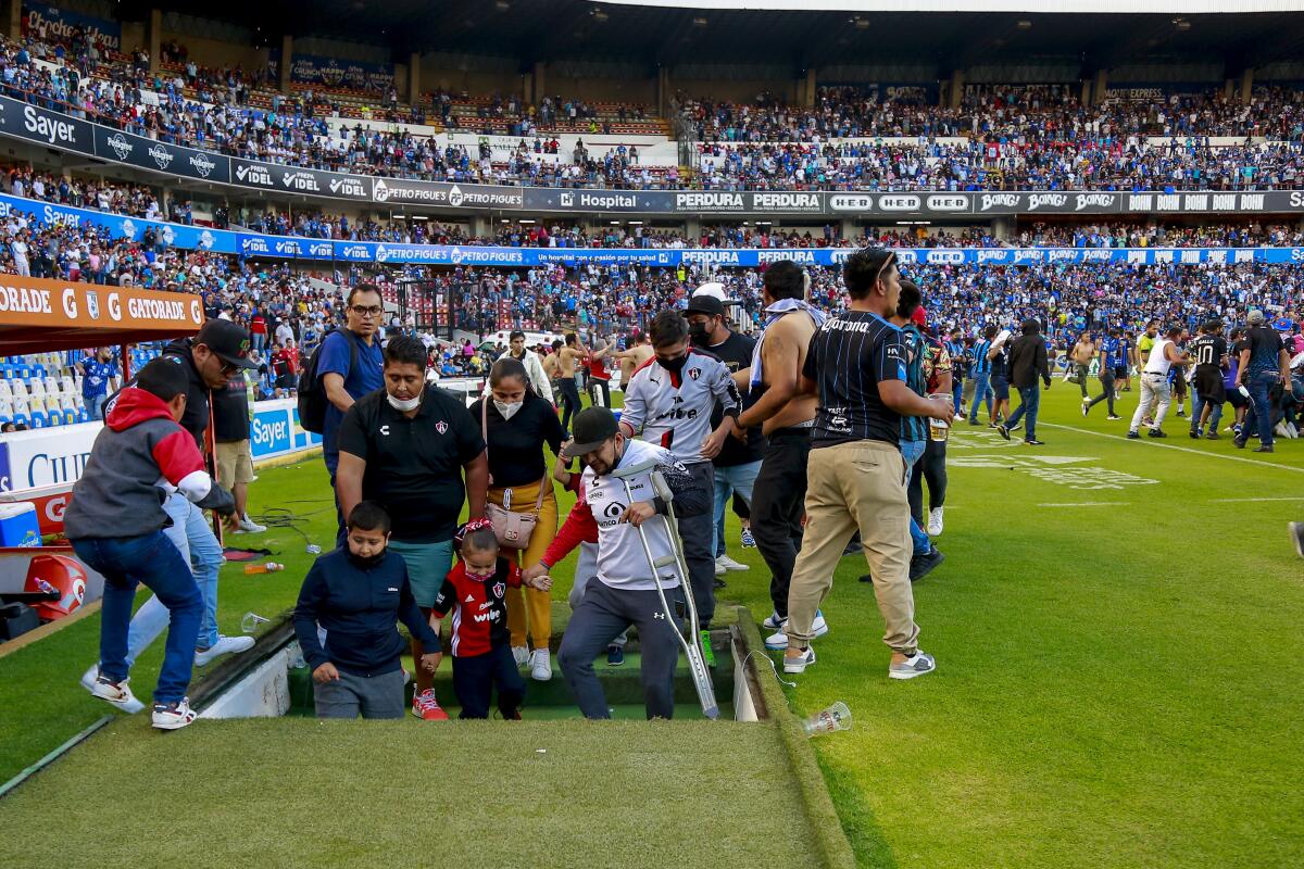 People go underneath a stadium full of people.