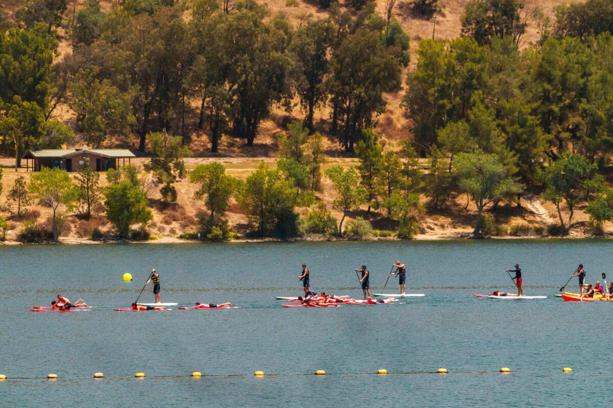A line of stand-up paddleboarders on Castaic Lake.